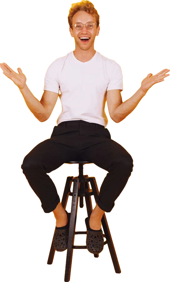 A man on a stool throwing his arms wide with joy