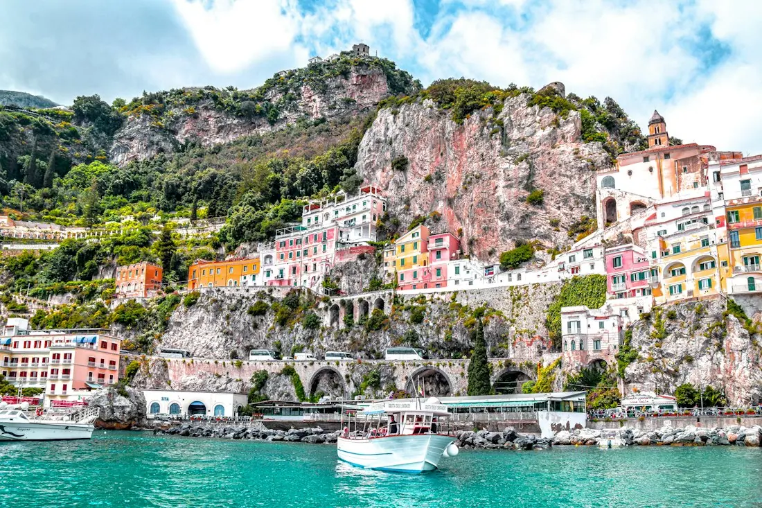 Colourful houses of Amalfi above turquoise water