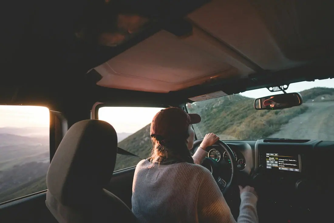 Woman at the wheel on a coastal road